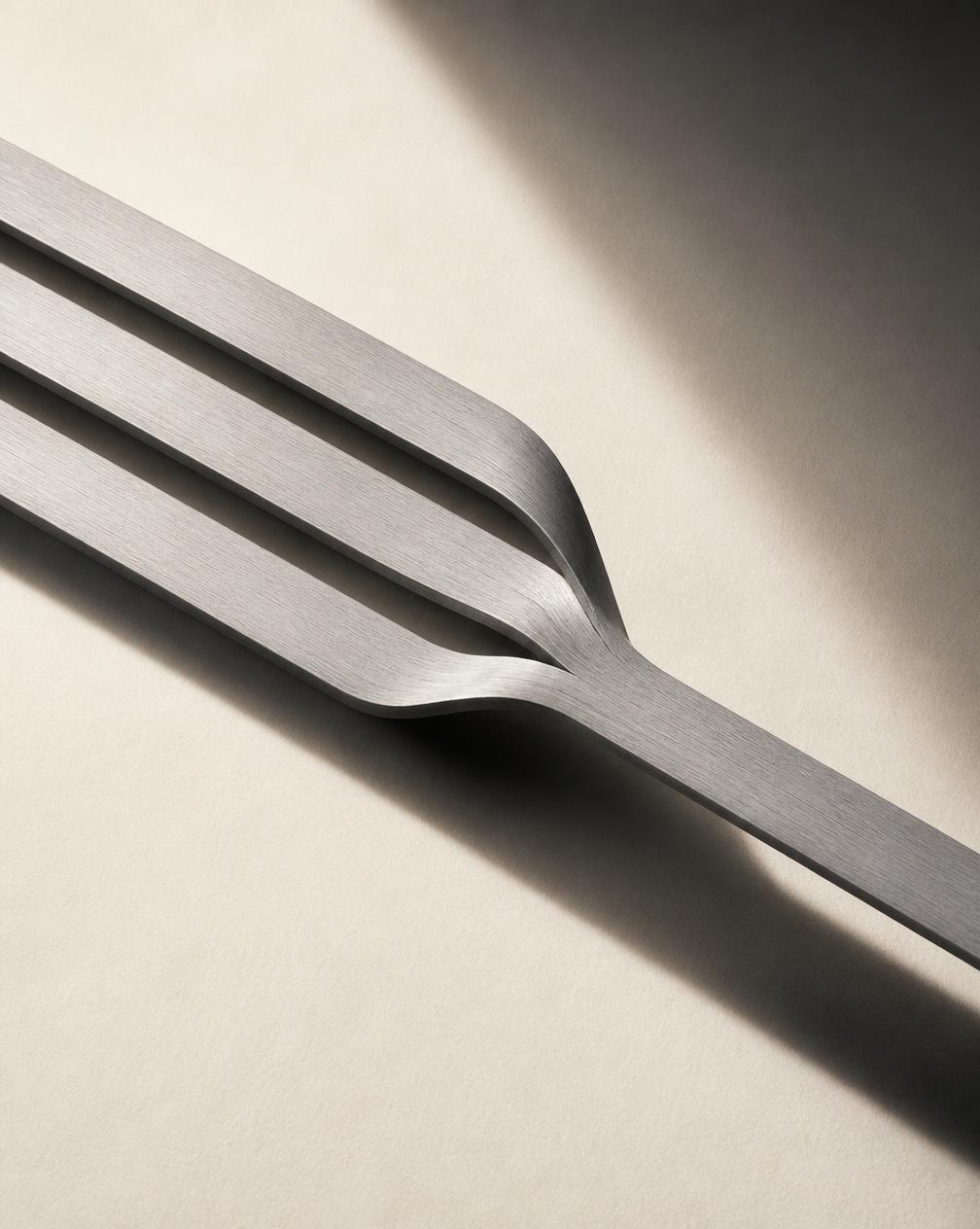 Three brushed aluminium ribbons converging into a single channel